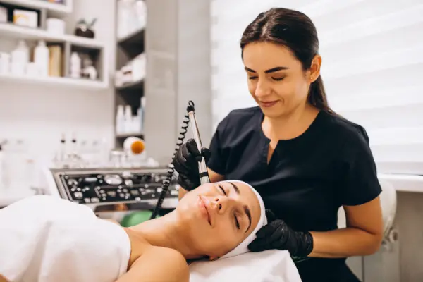 Aesthetic expert performing a skincare treatment at a medical spa, providing Botox, fillers, and wellness consultations.