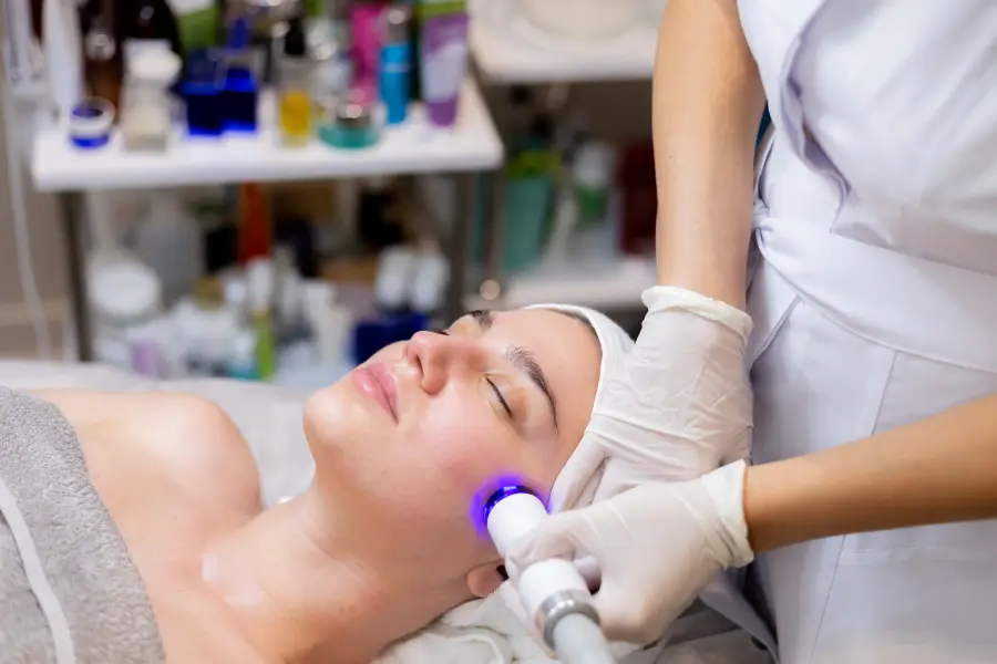 A young woman receiving a professional facial treatment at a medical spa